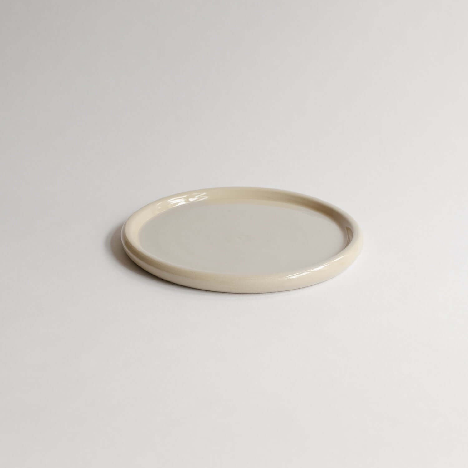 Unique Aleah Creme Plate, 19cm, with a refined glossy finish. Each lovingly handcrafted piece varies slightly, showcasing the beauty of its creation. von viola beuscher ceramics